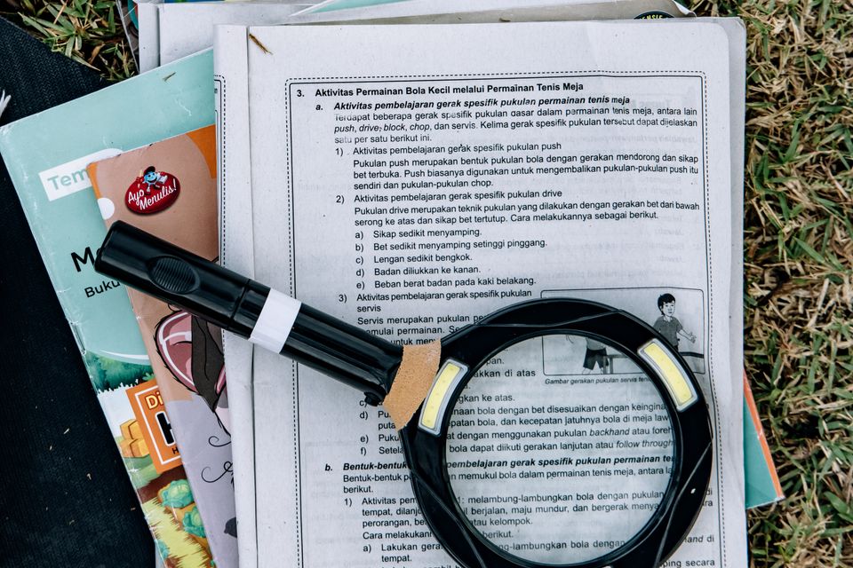 A magnifying glass over printed study notes